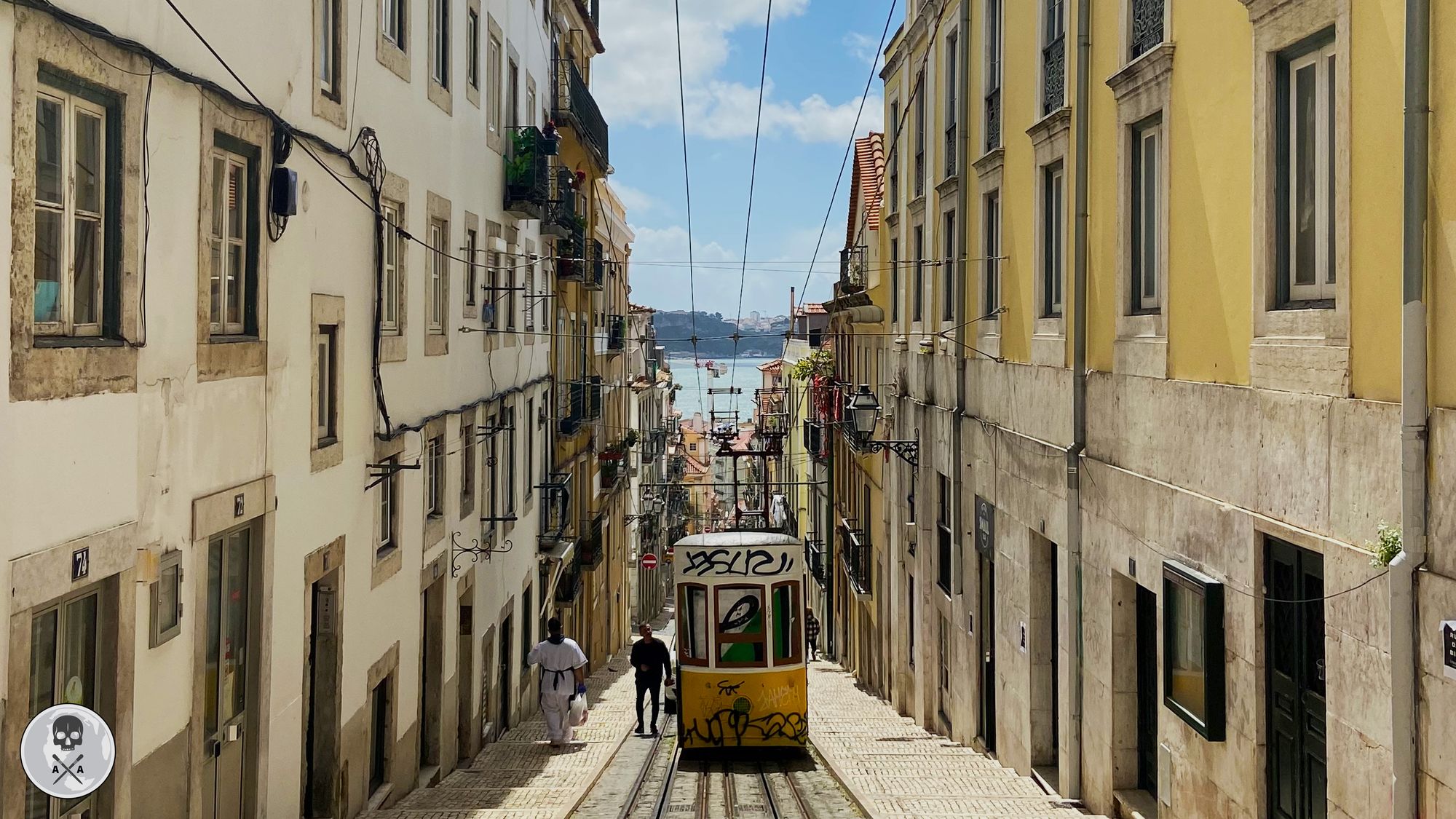 Yellow tram in a narrow street in Lisbon, Portugal