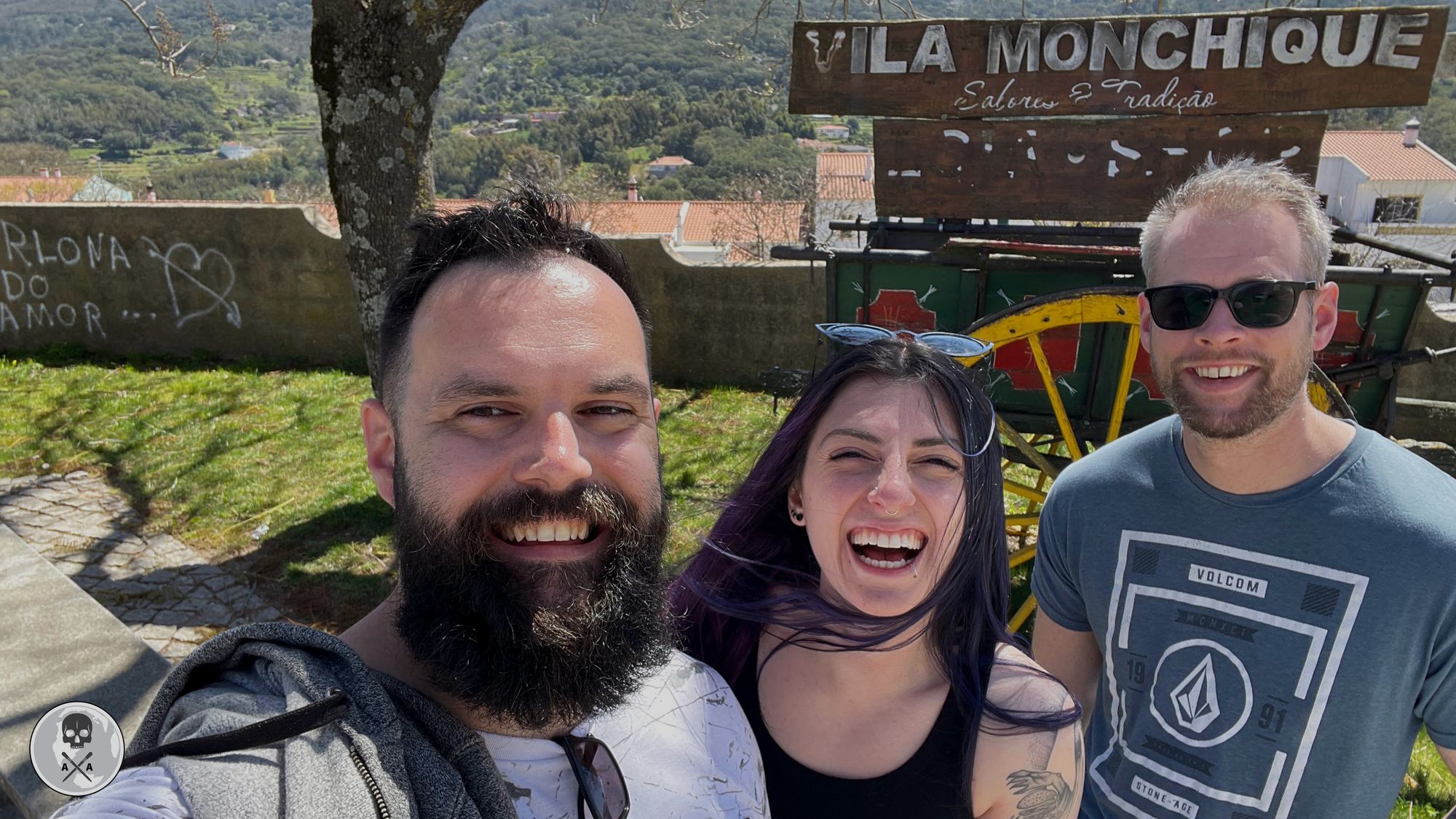 Alek, Alexia and Paul all smile in front of a Vila Monchique sign